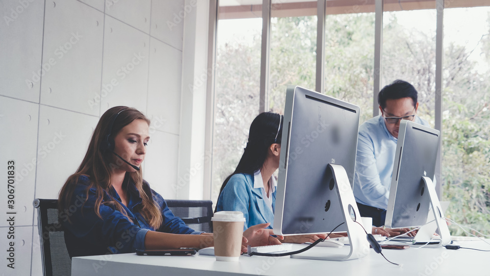 Aufkleber customer support agent or call center with headset works on desktop computer while supporting the cu