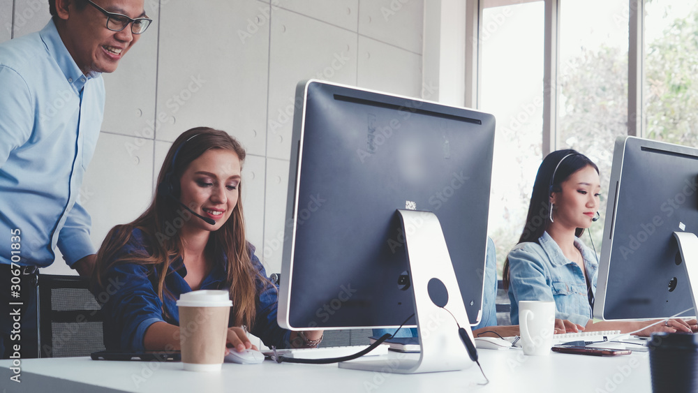Aufkleber customer support agent or call center with headset works on desktop computer while supporting the cu