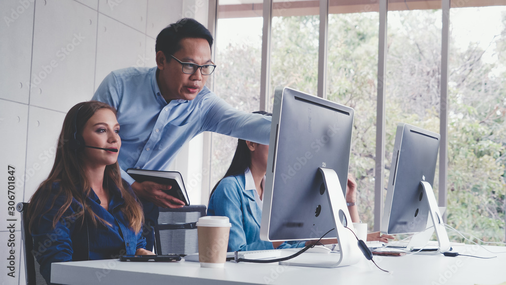 Aufkleber customer support agent or call center with headset works on desktop computer while supporting the cu