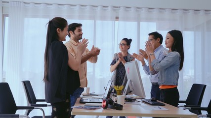 Successful business people group celebrating project success at office. Team winner and collaboration achievement concept.