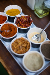 Various colored spices in recipients