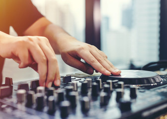 DJ mixing music on console at the club, Selective focus
