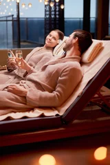 Fototapeten Beautiful caucasian couple in love relax spending time in spa center together, enjoy spa procedures, drinking champagne. isolated room © alfa27