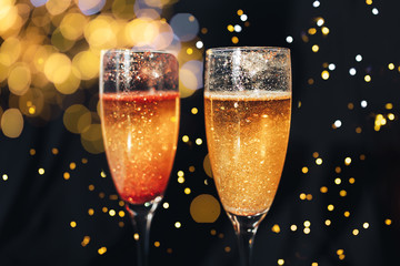 Happy New Year. Two shining glasses of champagne, christmas background. New year holiday.