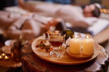 Attractive caucasian woman and man spend time in spa salon and enjoy drinking tea