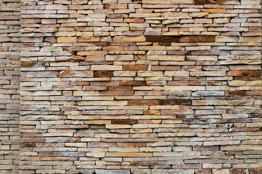 Natural brown and gray color of stone bricks wall background, Decoration outside wall of building.