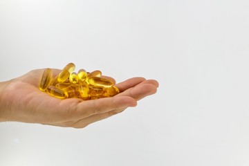 Fototapeta premium Evening Primrose oil capsules in hand which contains omega-6 fatty acids.