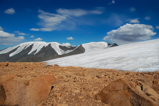colorful mountains, low clouds over glacier; Tsast Uul (mesa), Mongolia