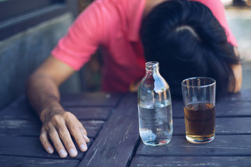 Fototapeta na wymiar Alcohol addicted man sleeping at the table