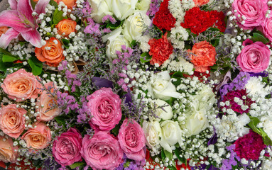 Mix  flowers (rose,carnation,chrysanthemum) with droplets in bouquet at flower market,pattern background,selective focus