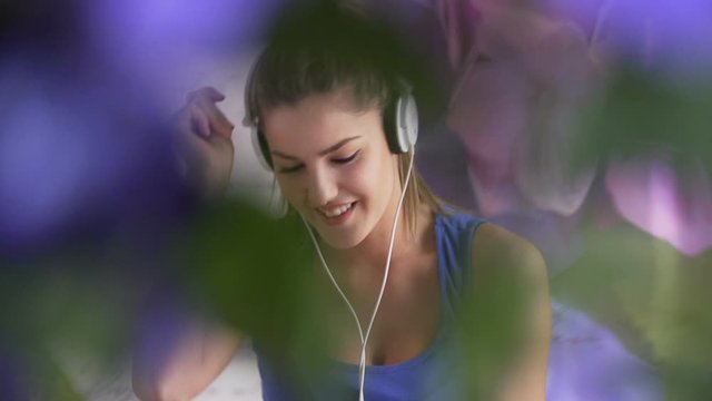A girl in the headphones is dancing