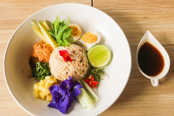 Thai Southern Spicy Rice Salad with Vegetables on white plate, Thai local food.