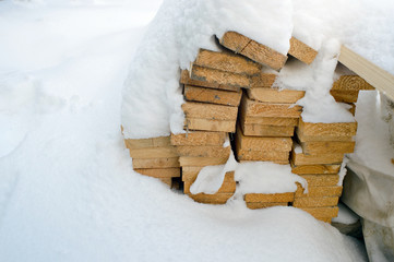 wooden planks covered by snow