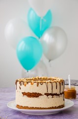 Birthday cake. Snickers homemade holiday cake with caramel, nougat, peanuts and chocolate.