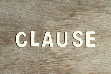 Alphabet letter in word clause on wood background