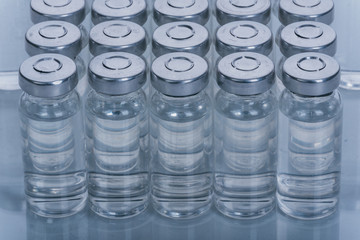 Glass medical ampoule vial for injection. Medicine is dry white drug penicillin powder or liquid...