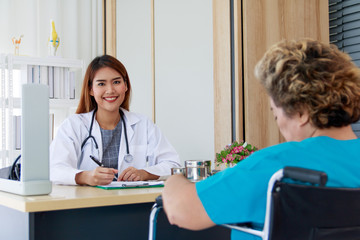 Portrait of a beautiful Asian woman doctor smiling and interviewing the patient's symptoms.
