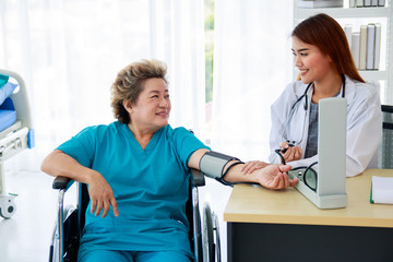 Portrait of an old female patient smiling While being treated by a beautiful woman doctor