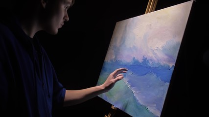 Artist copyist paint seascape with ship in ocean. Craftsman decorator draw as boat sail on blue sea...