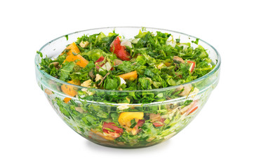 Salad with tomatoes, bell pepper, spinache, red lettuce, dill,parsley and grilled mushrooms. Homemade food. Concept for a tasty and healthy vegetarian meal. Big glass bowl isolated on white background