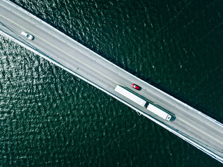 Aerial view of bridge road with cars over lake or sea in Finland