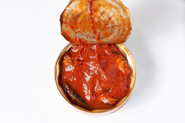 Photo on a whitish background canned seafood open jar.