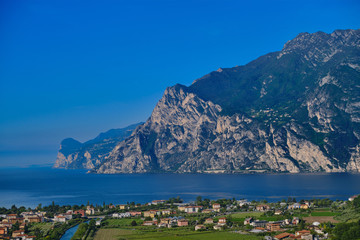 Obraz premium Panorama of Lake Garda surrounded by mountains in Riva del Garda, Italy. Linfano, Italy