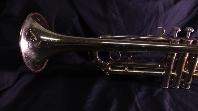 Brass trumpet only on a black background