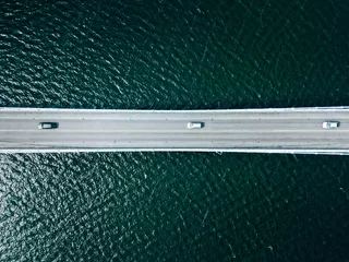 Foto op Aluminium Aerial view of bridge road with cars over lake or sea in Finland © nblxer