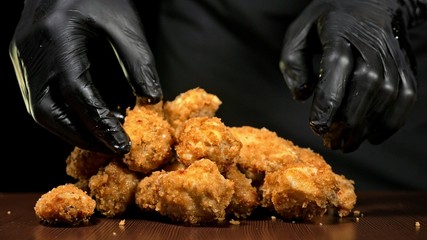 Cool beautiful fresh juicy cooked chicken wings in breading. Buffalo wings spread on food white...