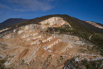 Air view of a marble quarry. Panoramic view of the extraction of marble in the quarry. Technique in the marble quarry of Brescia, Italy. Open pit mine.
