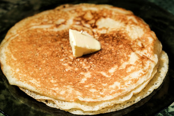 the pancakes with sour cream on a plate