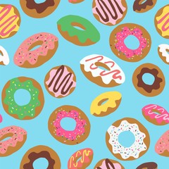 Seamless repeat pattern with colourful colorful donuts doughnuts with sprinkles and icing tossed on a blue background