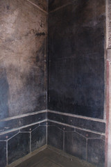 Black fresco on the wall in villa of the mysteries in Pompeii (Pompei)