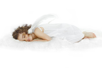 Fototapeta na wymiar Little girl with curly hair, in white dress and wings, sleeping with his hand under the cheek on white fur, studio shooting. Horizontal view.