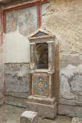 Mosaic lararium in house of the Skeleton in Ancient Ercolano (Herculaneum) city ruins