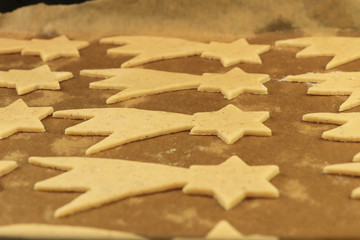 Many golden comets ready for baking. Symbol of rebirth and wishes. Ideal decoration for christmas dinner. Santa Claus or Baby Jesus will appreciate these sweets. Concept of creativness