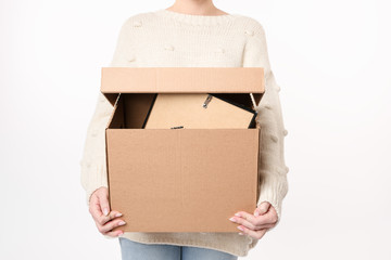 Close up shot of woman holding full cardboard with  copy space for handwriting. Moving day concept....
