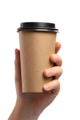 Breakfast and coffee theme: man's hand holding empty paper coffee cup with a brown plastic cap isolated on a white background in the studio, advertising coffee