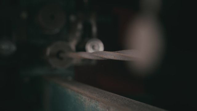 Forge workshop on table. Smithy manual production. Metal pipe craft electric twist wrought iron machine. The blacksmith makes iron products for manufacture of fireplaces, stoves.
