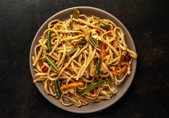 Asian vegetarian food udon noodles with Beijing cabbage, carrots, green beans, bell pepper, onions...