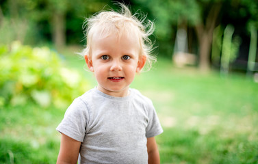 Portrait of little boy during playing in backyard