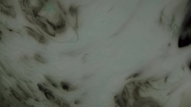 Surface of gas planet with whirlwinds and hurricanes is actually ink experiment shot top down. Cosmic gas implosion or edge of planet  with twisters.