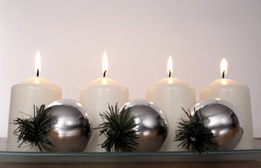 Flames on candles with Christmas decoration in pastel color tone