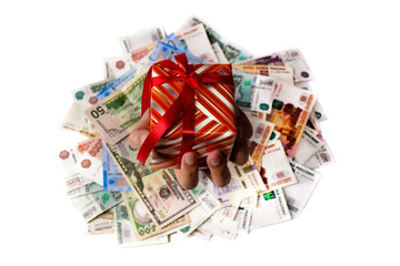 Obraz na płótnie Canvas hand with a gift on a background of money