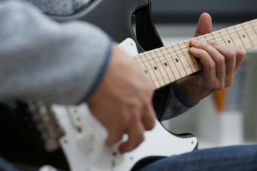 Fototapeta premium Male hands at home play and tun