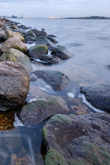 Obraz premium night clouds and lights above industrial port of city Riga in Latvia