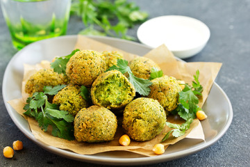Fresh falafel balls on a dark background.