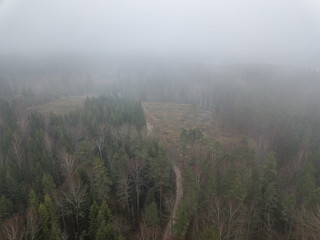 fog over forests and lakes in countryside. drone image from above
