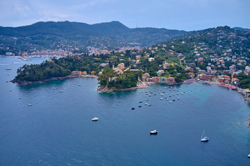 Fototapeta na wymiar Aerial view of the harbor city of Santa Margherita Ligure, Italy. Yachts, boats, ships in the parking lot in the bay of the resort town. Early in the morning